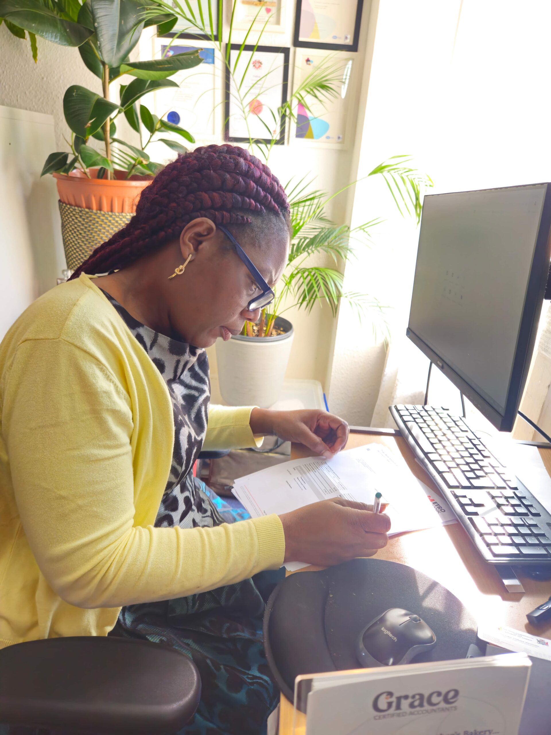 Dora Ngoma preparing Making Tax Digital records at her desk for a self-employed UK client.
